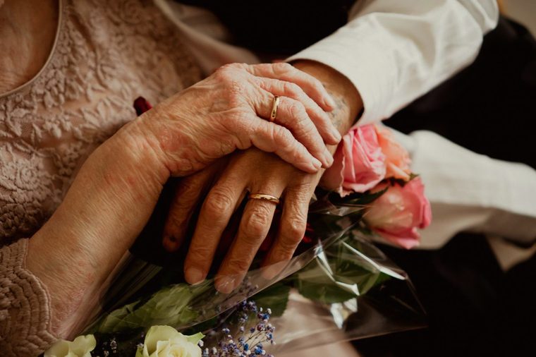 An older couple holding hands